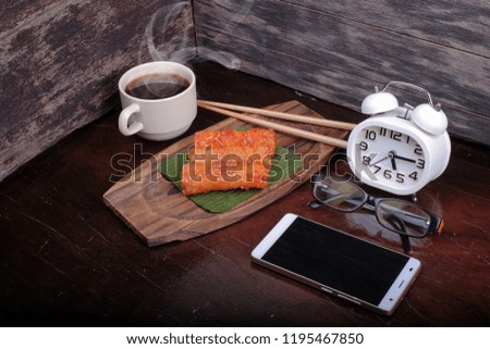 Hot coffee , smartphone  and alarm clock with popia on the table : Concept for coffee time