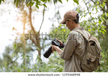 Professional man photographer taking camera outdoor portraits with prime lens in the photography nature.  