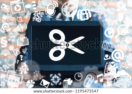 Man offers a laptop with scissors icon on a virtual doodle interface. Edit media content concept. Photo Video Music File Design Development concept.