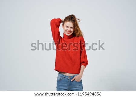 happy woman red sweater blue jeans                            