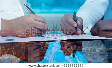 Businessmen hands signing documents on Riyadh skyline city scape background multi exposure Royalty-Free Stock Photo #1195511980