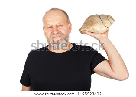 Picture of an elderly man holding a snail fossil