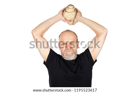 Picture of an elderly man holding a snail fossil