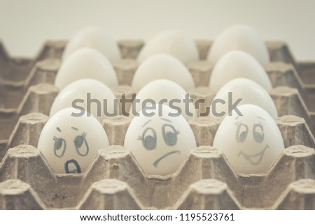 white chicken eggs with painted faces