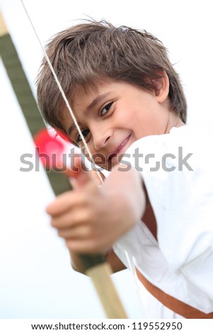 Little boy with bow and arrow Royalty-Free Stock Photo #119552950