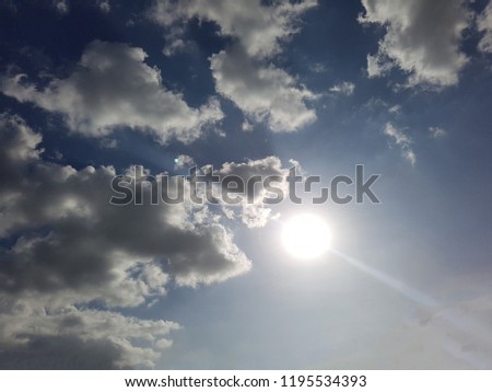 Sun on Blue Sky looks beautiful, pictures is taken of dark clouds on blue sky with Sunshine. Sun with white clouds on blue sky 