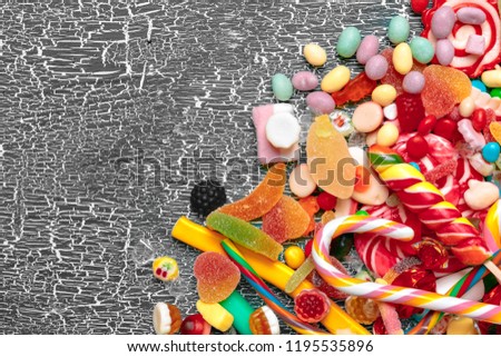 Colorful candies on old background
