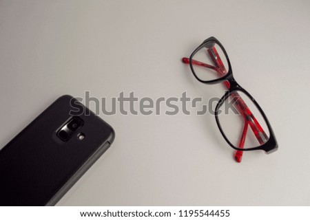 glasses with a smartphone on a white background