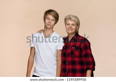 Family portrait. Smiling mother and son wearing casual clothing
