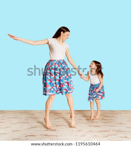 mother and daughter jumping on the background isolated