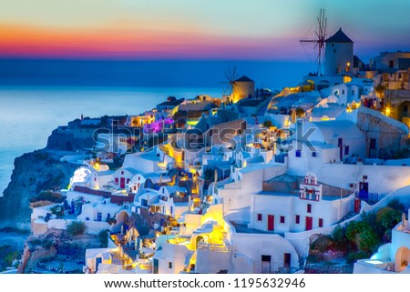 Travel Concepts. Skyline of Oia Town with Traditional White Architecture and Iconic Windmills in Village of Santorini in Greece.World Famous Resort.Horizontal Image Composition