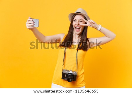 Tourist woman in summer casual clothes, hat doing taking selfie shot on mobile phone isolated on yellow background. Female passenger traveling abroad to travel on weekends getaway. Air flight concept