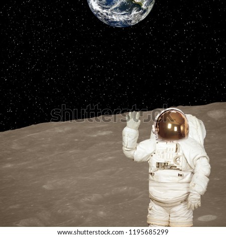 Astronaut on the moon. Blue fascinating earth on the background. Elements of this image furnished by NASA.
