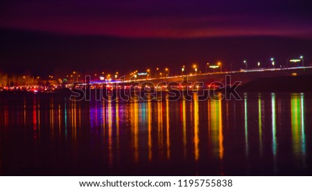 Blurred city lights with bokeh effect reflected on water