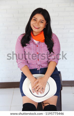 Beautiful cow girl with block walls background.
