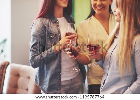 Picture presenting happy group of friends with red wine.