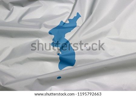 Fabric flag of Unification  Korea. Crease of Unification Korean flag background, Korean Peninsula in blue on white. Royalty-Free Stock Photo #1195792663