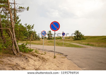 Prohibition signs for cars standing near the seashore.