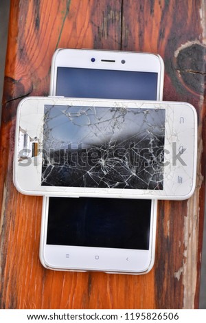 broken phone on wooden background