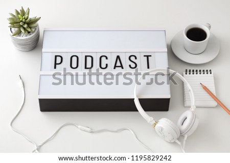 Podcast word on lightbox with headphones, podcast concept