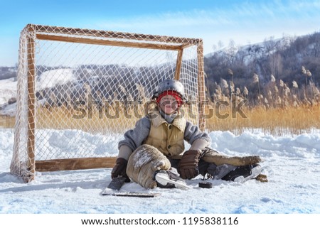 Portrait of a tired goalkeeper at the gate on a frozen lake