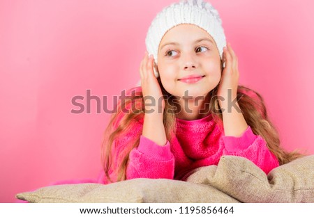 Girl long hair dream pink background. Kid dreamy lean on pillows. Winter season coziness attribute. Winter season concept. Winter fashion accessory. Kid girl knitted hat. Winter accessory concept.