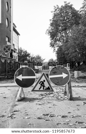 Repair works on the road, road signs: Roadworks, Turn right and Turn left, monochrome
