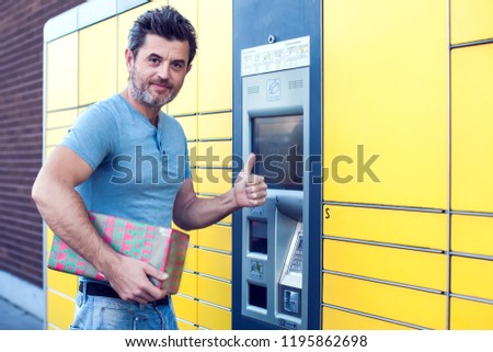 man client using automated self service post terminal machine or locker to deposit the parcel for storage