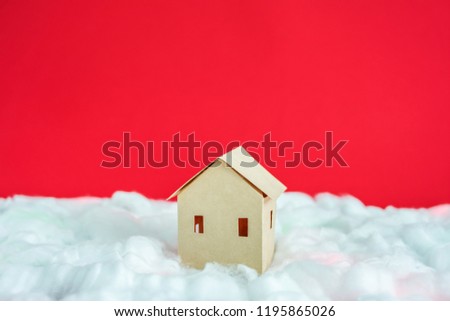 Paper Home, white snow, red background with copy space, for advertising, close up