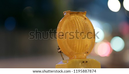 Caution light in the road at night
