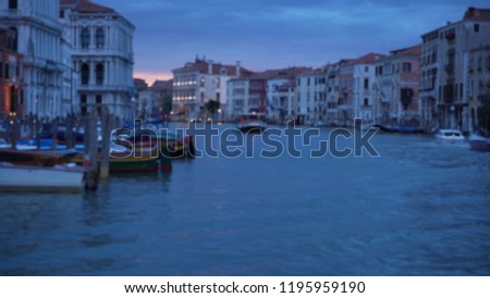 Scenic view of boats crossing the Grand canal in early evening past old homes