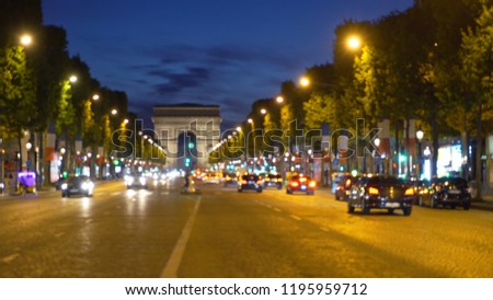 Blurry backdrop of Champs-Elysees in Paris with Arc de Triomphe in distance