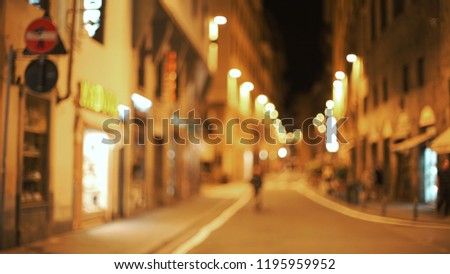 Out of focus backdrop of metropolitan Florence city street at night