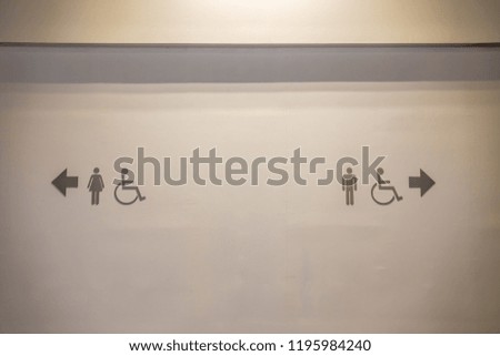 male and female toilet signs on wall