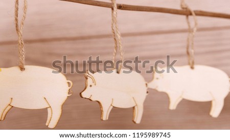 wooden toys on the Christmas tree-pigs, new year boar, Christmas background, vintage toys on the Christmas tree, a garland of pigs