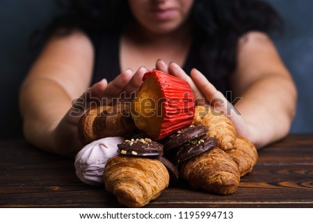 Sugar addiction, nutrition choices, motivation and healthy lifestyle. Cropped portrait of overweight woman refusing sweet food Royalty-Free Stock Photo #1195994713