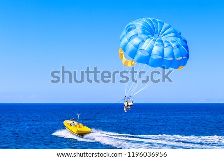 Blue parasail wing pulled by a boat. Sea summer recreation  - Cyprus. Royalty-Free Stock Photo #1196036956
