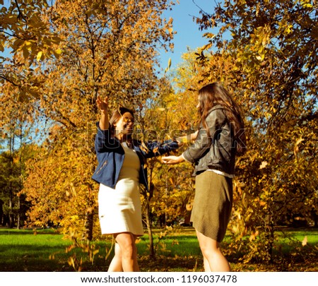 mature real mother with daughter outside autumn fall in park