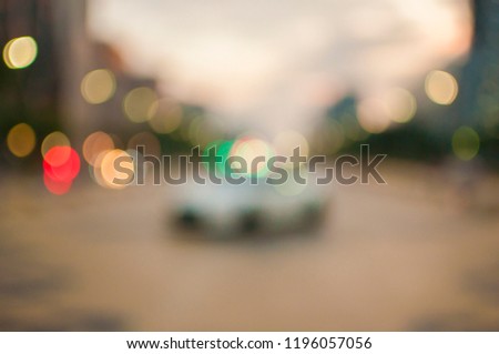 Blurry image of inside cars with bokeh lights with traffic jam and raining on night time for background usage.