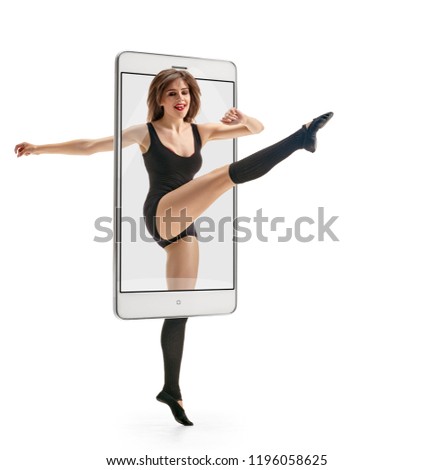 Photo of young beautiful modern female dancer jumping, concept virtual reality of the smartphone. going out of the device