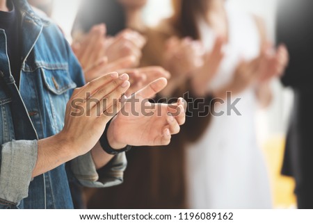 Selective Focus on hands. Creative designers audience applauding at a business seminar. Asian People listening and clapping at conference and presentation. Royalty-Free Stock Photo #1196089162