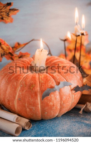 Postcard, Halloween background: pumpkins, candles, bats on blue background