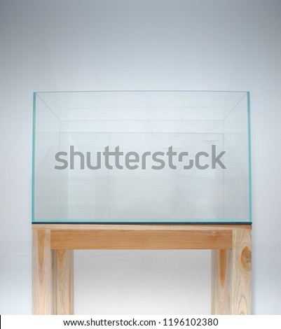 Empty glass aquarium tank on wood table with white background was prepared for set up shrimp or fish tank