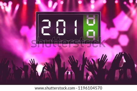 Silhouette of crowd people hands celebrating new year in the carnival with a flip clock with number 2018 change to number 2019
