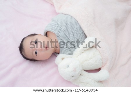 4 weeks old newborn baby wrapped in grey blanket Royalty-Free Stock Photo #1196148934
