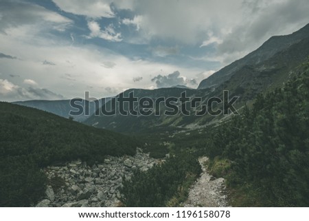 hiking trail in tatra mountains in Slovakia. mounatin view in late summer before autumn, clear sky with some clouds - vintage retro look