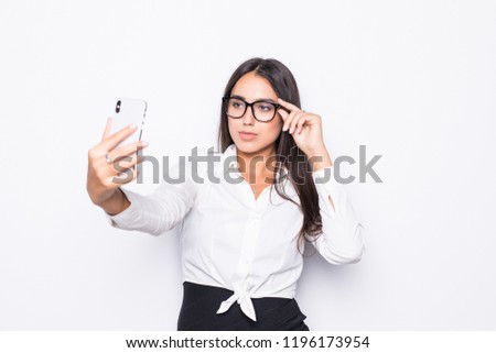 Closeup of beautiful playful business woman making selfie photo on isolated white background