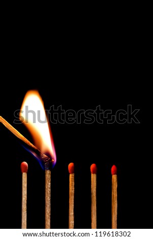 burn a row of matches on black background