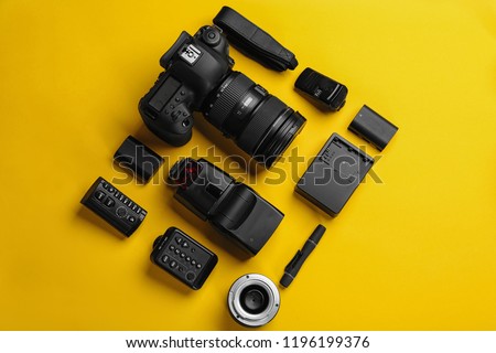 Flat lay composition with photographer's equipment and accessories on color background