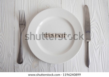 Words on white empty plate from wooden letters: Healthy diet food concept. 